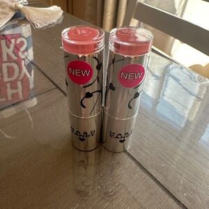 Two hard candy plumping lipsticks in shade infamous 851